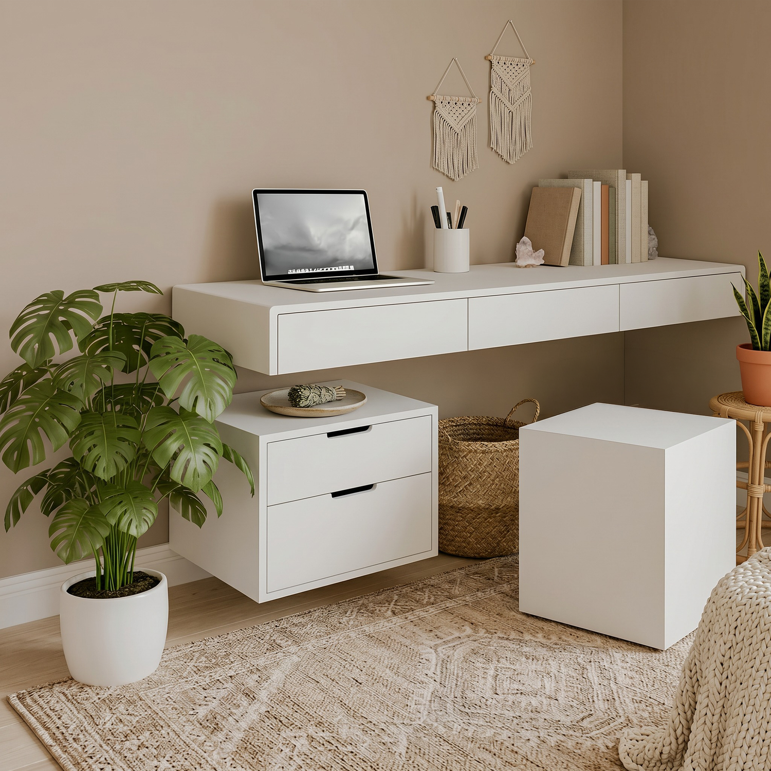 Floating white desk with two-drawer box unit, styled in a boho home office with monstera plant, laptop and macramé wall decor
