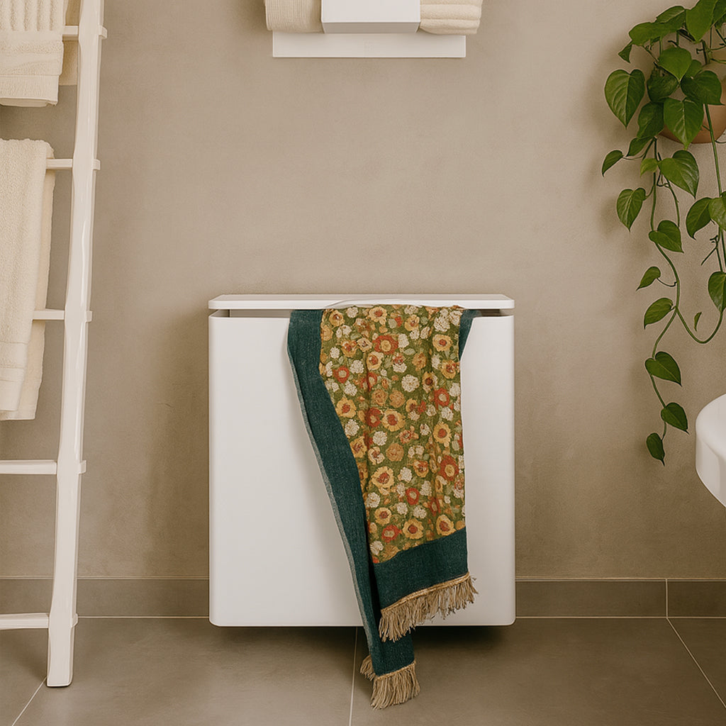 White radiator with a floral towel draped over it in a bathroom setting.